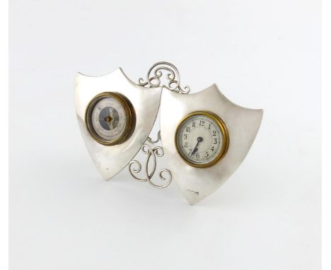 A silver clock and barometer, maker's mark worn, London 1896 of double shield form, with scroll wire-work decoration, pierced