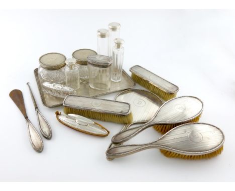 A matched silver dressing table set, Birmingham and Chester 1912 and London 1925, two designs, initialled 'D', comprising: a 