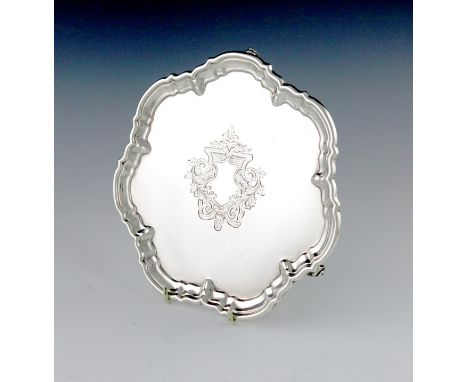 A silver waiter, by William Hutton and Sons, Sheffield 1912, shaped circular form, moulded border, the centre with an engrave