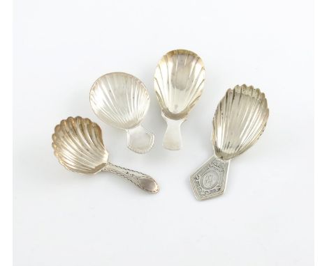 A small collection of four antique Irish silver caddy spoons, comprising: one with an elongated fluted bowl, by Richard Whitf