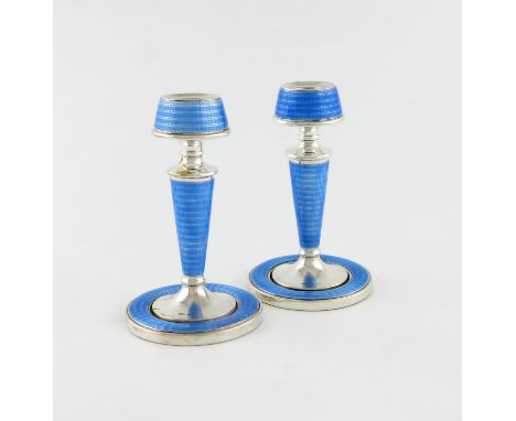 A pair of silver and enamel candlesticks, by A L Davenport Ltd, Birmingham 1928, tapering circular form, with pale blue ename