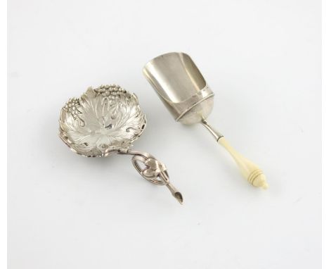 λ A George IV silver caddy spoon by Thomas Wallis, London 1820, shovel shaped bowl, turned ivory handle, plus a Victorian sil