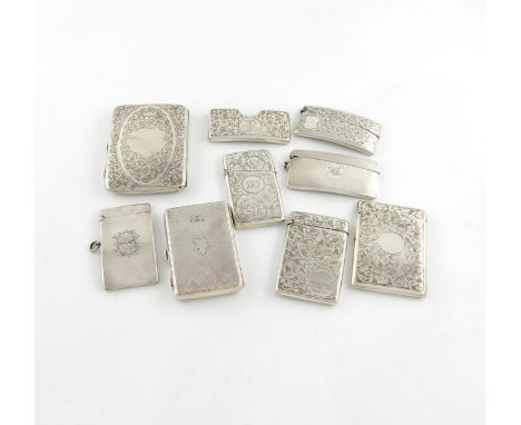 λ A small collection of nine silver card cases, comprising: an Edwardian one of rectangular form, engraved foliate scroll dec