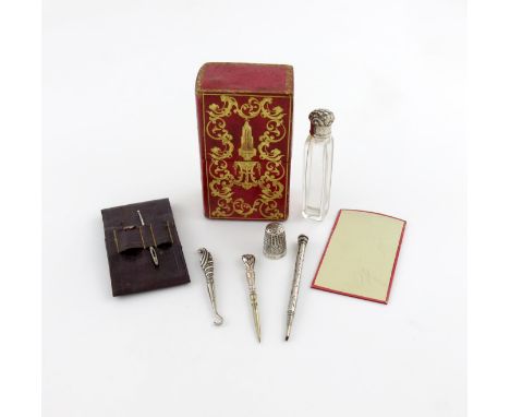 A Victorian leather lady's companion, the red leather bound case of rectangular form with tooled decoration, with various mat