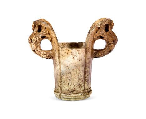 A CHINESE 'CHICKEN BONE' JADE LOBED TWO-HANDLED VASE  QING DYNASTY, 18TH CENTURY  The handles carved with bats and vine, with