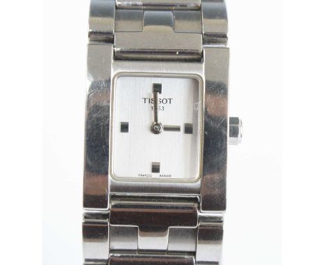 A modern lady's Tissot steel cased tank watch, the silvered dial signed Tissot 1853, quartz movement, on integral steel brace