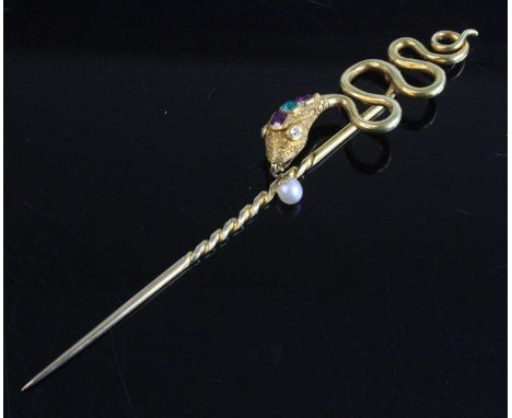 A yellow metal stick pin depicting a snake, set with two rectangular rubies measuring between approx 1.85 x 1.65mm and 2.5 x 