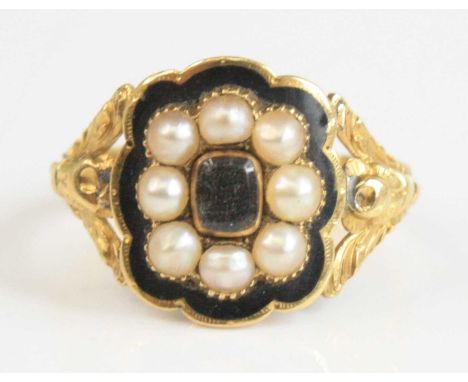 An 18ct yellow gold, pearl and enamel memorial ring, featuring a central 3.9 x 3mm rock crystal within a border of eight 2.85