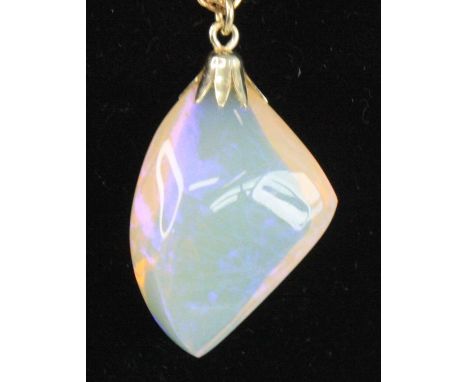 A contemporary polished and faceted opal pendant, measuring approx 29 x 19 x 10mm and weighing approx 22 carats, on 14ct gold