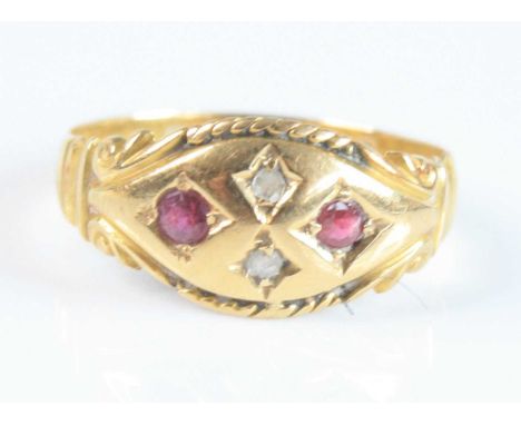 An 18ct yellow gold Edwardian ruby and diamond boat shaped dress ring, featuring two round faceted rubies and two rose cut di