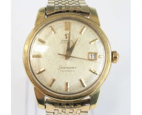 A gent's vintage Omega Seamaster calendar automatic wristwatch, having gold plated case with steel back, signed champagne dia