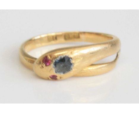 A late Victorian yellow metal snake ring, set with two 1.5mm ruby eyes and an oval sapphire to the head, sapphire dimensions 