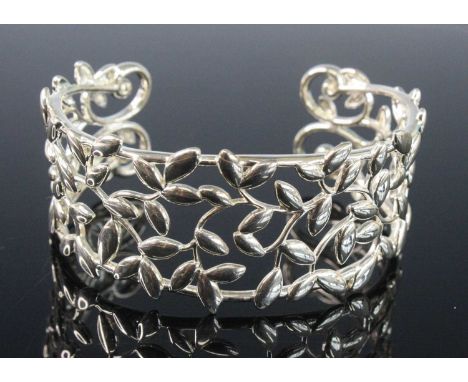 A Tiffany &amp; Co silver 'olive leaf' bangle, designed by Paloma Picasso, with silver assay and sponsor mark, 32g, dia.6cm, 