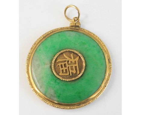 A Chinese yellow metal and green celadon jade disc pendant, centre set to either side with characters for longevity and luck,