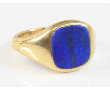 An 18ct yellow gold lapis lazuli cushion shaped signet ring, the lapis tablet measuring approx 11.7 x 11mm, size U½, gross we