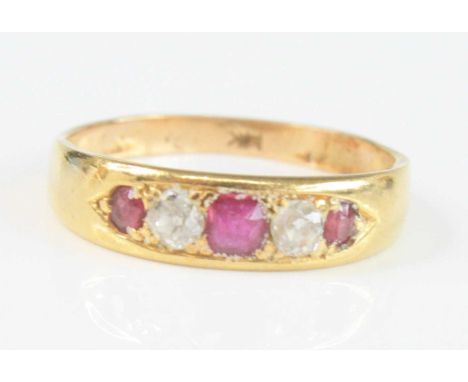 A yellow metal ruby and diamond half hoop eternity ring, comprising three graduated oval rubies alternating with two Old Euro