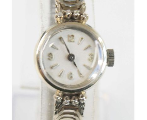 A lady's 18ct white gold manual wind dress watch, the unsigned silvered circular dial with Arabic quarter numerals, flanked t