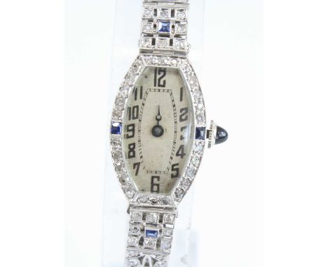 An Art Deco lady's 9ct white gold and diamond set cocktail watch, having a boat shaped Arabic dial within a round cut diamond