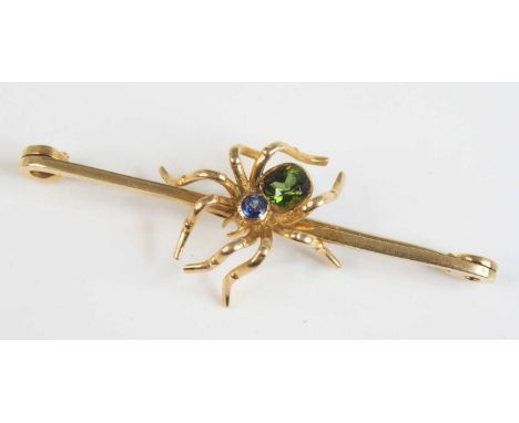 A 15ct gold spider set bar brooch having a sapphire set thorax and tourmaline set abdomen, 7.8g, 63mm