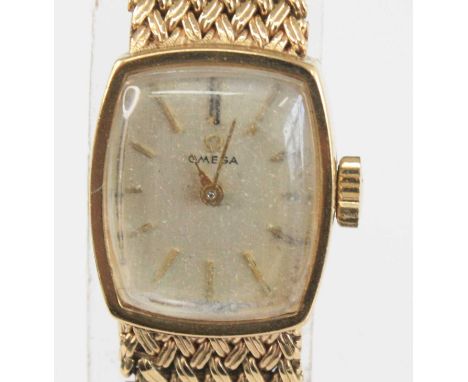 A vintage lady's Omega 9ct gold cased bracelet watch, having a signed champagne dial with baton markers, manual wind movement