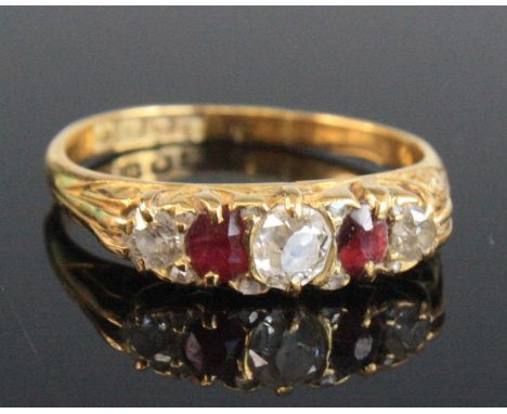 A George V 18ct gold, ruby and diamond five-stone ring, the graduated old cushion cut diamonds each interspersed with a singl