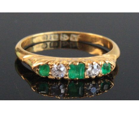 An Edwardian 18ct gold, emerald and diamond five-stone ring, the round cut stones in a carved line setting, Chester 1910, 2.4