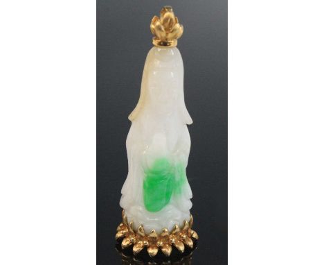A modern Far Eastern carved pale white celadon and included jade pendant, modelled as a standing Deity, with yellow metal lot