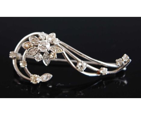 An 18ct white gold diamond flower brooch comprising 19 Old European cut diamonds in claw settings with roller catch fastening