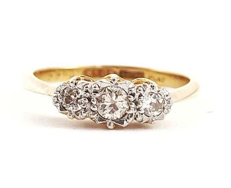 A three stone graduated brilliant-cut diamond ring, in illusion settings, estimated total diamond weight 0.25ct, I-K colour, 
