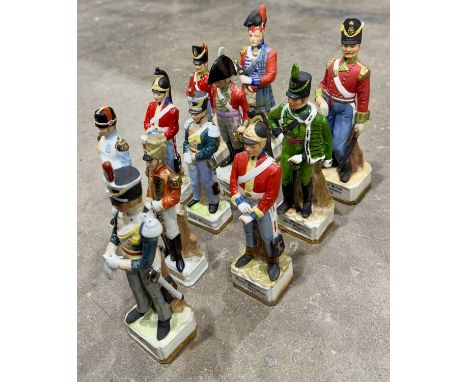 Collection of ceramic figurines of historical French military personnel, some marked with a crowned 'A', others Alfretto by M