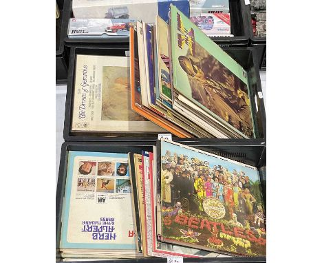 A collection of vinyl records including the Rolling Stones 'Big Hits (High Tide and Green Grass)', 'Love You Live', The Beatl