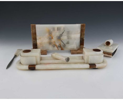 An Art Deco onyx desk set, circa 1930, black and green geometric slab construction, comprising clock, inkstand, letter knife,