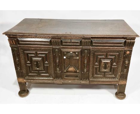 A provincial oak chest, 17th century, plane moulded top, geometric intricate carved panelling to front, plane panels to sides