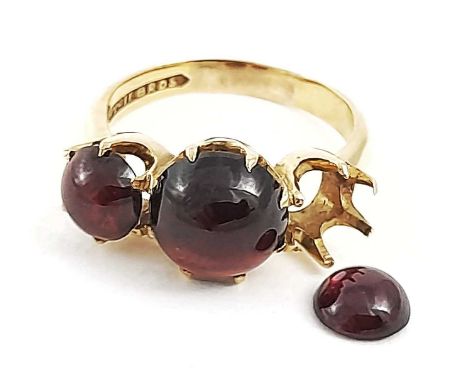 A 9ct gold garnet cabochon three-stone ring, at fault, one garnet currently loose from mount, ring size R, 6.5g