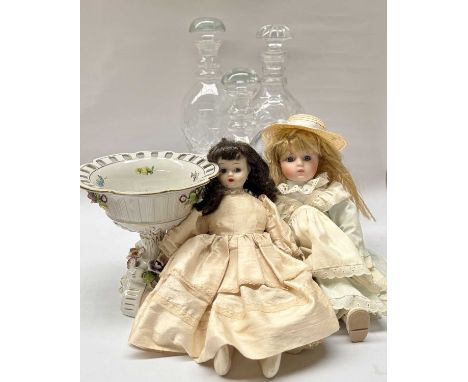 Three cut glass decanters with mushroom stoppers, two hand painted china dolls and a floral encrusted pedestal ceramic dish (