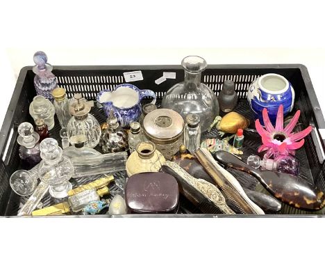 A faux tortoise shell comb with cat motif on silver handle and another, with a collection of perfume/sent bottles with silver