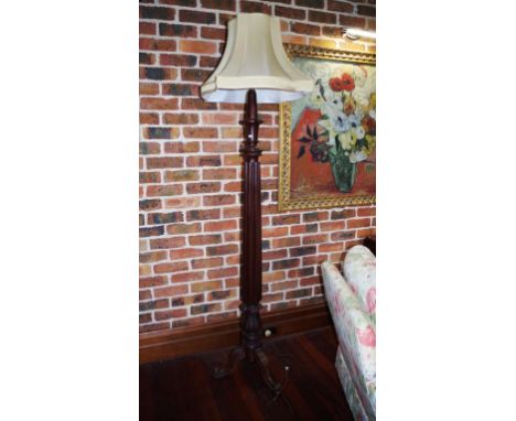 Large antique mahogany standard lamp on three legs, reeded central column with cream shade.