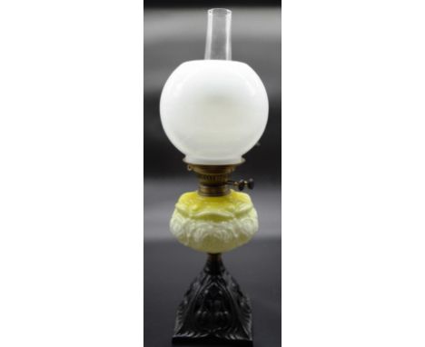 Victorian oil lamp with yellow glass reserve and white ball shade. 59cm tall.