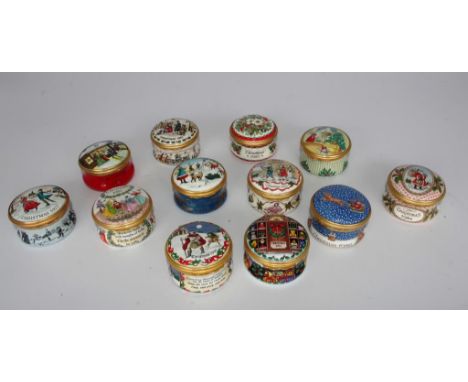 Twelve assorted Halcyon Days enamel Christmas year boxes. (one damaged)