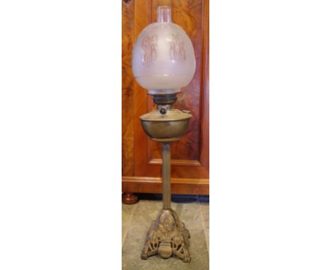 Tall Victorian brass oil lamp with frosted glass shade, and brass reservoir.