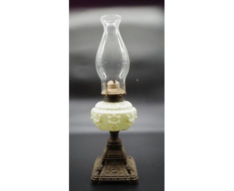 Victorian oil lamp with cream glass reserve on metal base, 49cm high