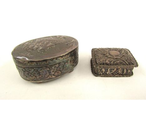 A silver lidded ring box with embossed decoration and associated oval metal box, 5.5cm x 8cm long 