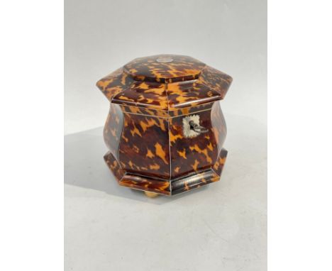 A tortoiseshell and ivory tea caddy of octagonal waisted form raised on four brass feet, 14.5cm tall x 16cm diameter, small r