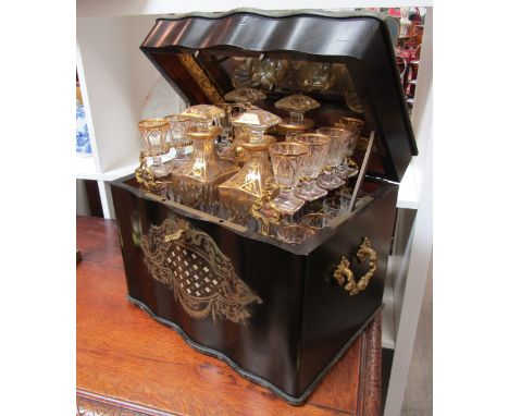 A 19th Century French serpentine liquor boulle work drinks cabinet, the rising lid activating a sprung interior with four ori