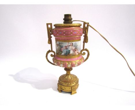 A French ormolu and porcelain lamp base, the body in a light pink decorated with classical figural and pastoral scenes, ename