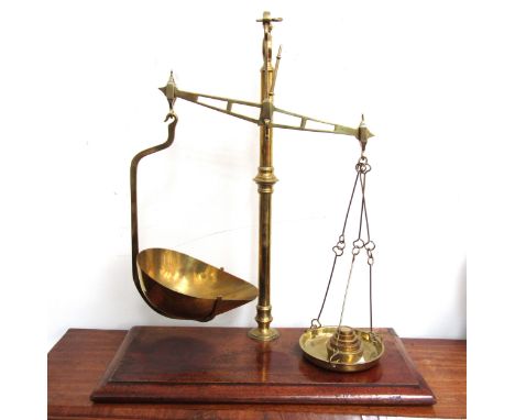 A set of 19th Century brass balance scales and weights, on mahogany plinth base, 46.5cm tall 