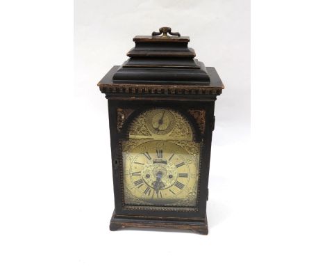 An 18th Century bracket clock in ebonised case. Roman brass chapter ring with applied spandrels and date subsidiary dial to a
