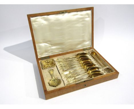 A 19th Century French silver gilt cased set of twelve tea spoons, sugar tongs, infuser and tea caddy spoon, 265g 