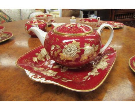 A highly ornate Wedgwood bone china six place tea service in Royal red and gilt acanthus and floral detail, 63cm tall, the to