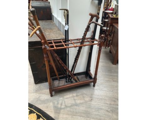 A circa 1900 mahogany stick-stand with twelve compartments and drip tray, ring turned detail 71cm x 61cm x 22cm 